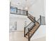 Grand foyer boasting soaring ceilings, staircase with dark wood railing, and elegant tile flooring at 30900 Spruceberry Ct, Wesley Chapel, FL 33543