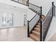 Bright foyer featuring a staircase with dark wood handrails and an open floor plan at 30900 Spruceberry Ct, Wesley Chapel, FL 33543