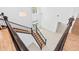 View from above of grand foyer boasting soaring ceilings, staircase with dark wood railing, and elegant tile flooring at 30900 Spruceberry Ct, Wesley Chapel, FL 33543