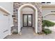 Close-up of the front entrance, framed by stone and featuring double doors with glass panels at 30900 Spruceberry Ct, Wesley Chapel, FL 33543