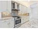 Bright kitchen featuring granite counters, stainless steel appliances, modern cabinets, and a gas cooktop at 30900 Spruceberry Ct, Wesley Chapel, FL 33543