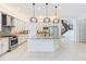 Bright modern kitchen with granite counters, stainless steel appliances, and decorative pendant lighting at 30900 Spruceberry Ct, Wesley Chapel, FL 33543