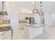 Bright kitchen featuring granite counters, stainless steel appliances, modern cabinets, and pendant lighting at 30900 Spruceberry Ct, Wesley Chapel, FL 33543