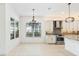 Open concept kitchen with granite counters, stainless steel appliances, and modern white cabinets at 30900 Spruceberry Ct, Wesley Chapel, FL 33543