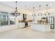 Open concept kitchen with granite counters, stainless steel appliances, and modern white cabinets at 30900 Spruceberry Ct, Wesley Chapel, FL 33543