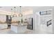 Gourmet kitchen with stainless appliances, an island with granite countertops, and pendant lighting at 30900 Spruceberry Ct, Wesley Chapel, FL 33543