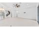 Open-concept living space with staircase, tile floors, and ceiling fan at 30900 Spruceberry Ct, Wesley Chapel, FL 33543