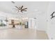 Open-concept living space featuring a modern kitchen and tile flooring at 30900 Spruceberry Ct, Wesley Chapel, FL 33543