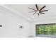 Bright living room featuring sliding glass doors and a modern ceiling fan at 30900 Spruceberry Ct, Wesley Chapel, FL 33543