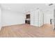Open living room with hardwood floors, mini-bar, and stairway at 30900 Spruceberry Ct, Wesley Chapel, FL 33543