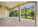 Spacious covered brick patio with screened enclosure and ceiling fan at 30900 Spruceberry Ct, Wesley Chapel, FL 33543
