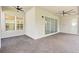Expansive covered patio features brick flooring, ceiling fans, and seamless access from interior with lots of space for entertaining at 30900 Spruceberry Ct, Wesley Chapel, FL 33543