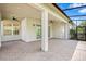 Large screened patio, ceiling fans, and beautiful brick flooring offering a perfect blend of indoor/outdoor living and entertaining space at 30900 Spruceberry Ct, Wesley Chapel, FL 33543