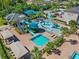 Aerial view of the community splash pad with water slides, fountains, and shaded seating areas at 30900 Spruceberry Ct, Wesley Chapel, FL 33543
