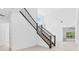 An interior staircase with wood treads, dark wood handrails, and views of other living spaces at 30900 Spruceberry Ct, Wesley Chapel, FL 33543