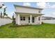 The covered patio and sliding glass doors provide a scenic view of the landscaped and fenced backyard at 3108 W Ballast Point Blvd, Tampa, FL 33611