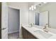 Elegant bathroom showcasing a double sink vanity with large mirror, modern lighting and design at 3108 W Ballast Point Blvd, Tampa, FL 33611