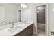 Modern bathroom featuring double sink vanity with large mirror and tiled shower for a luxurious feel at 3108 W Ballast Point Blvd, Tampa, FL 33611