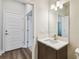 Bathroom featuring a white vanity with a decorative mirror at 3108 W Ballast Point Blvd, Tampa, FL 33611