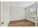 Bright, empty bedroom with wood flooring and large window with blinds at 3108 W Ballast Point Blvd, Tampa, FL 33611