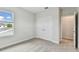 Bright bedroom features a double door closet, plush carpet, and a window providing natural light at 3108 W Ballast Point Blvd, Tampa, FL 33611