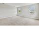 Spacious bedroom with plush carpeting, two windows that provide ample natural light, and neutral paint for any style at 3108 W Ballast Point Blvd, Tampa, FL 33611