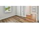 An empty bedroom showcases wood floors, white walls, and bright natural light at 3108 W Ballast Point Blvd, Tampa, FL 33611