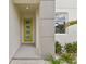 The front entryway features a bright green door and a small well maintained garden area at 3108 W Ballast Point Blvd, Tampa, FL 33611
