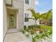 Close-up on the modern entrance featuring a stylish green front door and landscaped garden at 3108 W Ballast Point Blvd, Tampa, FL 33611