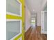 View through the bright, glass-accented front door to the hall with wood floors at 3108 W Ballast Point Blvd, Tampa, FL 33611