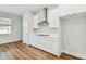Bright kitchen with white cabinetry, stainless steel hood, and quartz countertops at 3108 W Ballast Point Blvd, Tampa, FL 33611