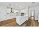 Bright kitchen features modern, white cabinetry, stainless steel appliances, and quartz countertops at 3108 W Ballast Point Blvd, Tampa, FL 33611