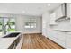 Modern kitchen island with stainless steel sink overlooking the lush backyard at 3108 W Ballast Point Blvd, Tampa, FL 33611