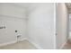 Bright laundry room featuring tile floor, shelving, and convenient washer/dryer hookups at 3108 W Ballast Point Blvd, Tampa, FL 33611