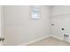 Well-lit laundry room with tile flooring, window, shelving and washer/dryer hookups for convenience at 3108 W Ballast Point Blvd, Tampa, FL 33611