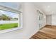 Bright living room view with a window overlooking a green backyard space at 3108 W Ballast Point Blvd, Tampa, FL 33611