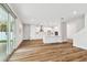 Bright open-concept living space with wood floors and modern white kitchen at 3108 W Ballast Point Blvd, Tampa, FL 33611