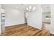 Bright living room with hardwood flooring, a modern chandelier, and natural light at 3108 W Ballast Point Blvd, Tampa, FL 33611