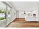 Sunlit living room featuring wood floors and sliding doors to the backyard at 3108 W Ballast Point Blvd, Tampa, FL 33611