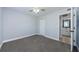 This carpeted bedroom has a ceiling fan and attached bathroom with a door for added privacy at 3143 Mission Grove Dr, Palm Harbor, FL 34684