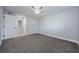 Bedroom featuring neutral carpet, ceiling fan and white trim at 3143 Mission Grove Dr, Palm Harbor, FL 34684