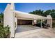This carport features a two car parking area and two separate storage units at 3143 Mission Grove Dr, Palm Harbor, FL 34684