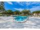 Enjoy a refreshing swim in the community pool with lounge chairs and seating at 3143 Mission Grove Dr, Palm Harbor, FL 34684