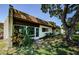 A charming condo featuring a beautiful lawn, landscaping, and mature trees at 3143 Mission Grove Dr, Palm Harbor, FL 34684