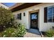 Inviting front entrance with a stylish door, enhanced by lovely landscaping and warm natural light at 3143 Mission Grove Dr, Palm Harbor, FL 34684