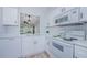 Bright kitchen featuring white cabinets, stainless appliances and wood look flooring at 3143 Mission Grove Dr, Palm Harbor, FL 34684
