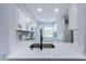 Bright kitchen featuring white cabinets, stainless appliances and modern countertops at 3143 Mission Grove Dr, Palm Harbor, FL 34684