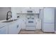 This kitchen features white cabinets, modern appliances and stylish countertops at 3143 Mission Grove Dr, Palm Harbor, FL 34684