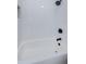 A bright white tiled shower features matte black fixtures at 3143 Mission Grove Dr, Palm Harbor, FL 34684