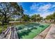 Shuffleboard court next to mature landscaping, ideal for outdoor games at 3143 Mission Grove Dr, Palm Harbor, FL 34684